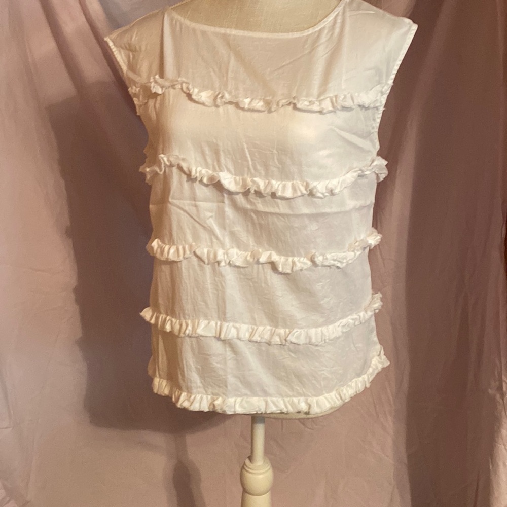 White ruffled sleeveless top